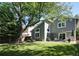 Inviting backyard with a well-maintained lawn, patio seating, and mature trees at 7869 S Valentia St, Centennial, CO 80112