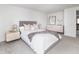 Bright bedroom featuring a bed with a gray headboard, white bedding, and stylish nightstands with lamps at 7869 S Valentia St, Centennial, CO 80112