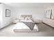 Serene bedroom with neutral tones, featuring a comfortable bed and minimalistic decor for a relaxing ambiance at 7869 S Valentia St, Centennial, CO 80112