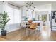 Open-concept dining area with hardwood floors, modern lighting, adjacent to the kitchen and living room at 7869 S Valentia St, Centennial, CO 80112
