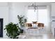 Dining area with hardwood floors, modern lighting, and large windows providing natural light at 7869 S Valentia St, Centennial, CO 80112