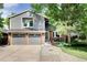 Charming two-story home with gray siding, brick accents, attached two-car garage, and well-maintained landscaping at 7869 S Valentia St, Centennial, CO 80112