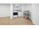 Bright laundry room featuring a washer, dryer, and shelving for ample storage at 7869 S Valentia St, Centennial, CO 80112