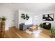Spacious living area with hardwood floors, modern decor, and large window view at 7869 S Valentia St, Centennial, CO 80112