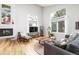 Bright living room with hardwood floors, fireplace, large windows, and comfortable seating at 7869 S Valentia St, Centennial, CO 80112