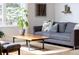 Cozy living space featuring modern couch, wood coffee table, and decorative pillows at 7869 S Valentia St, Centennial, CO 80112