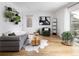 Comfortable living room with hardwood floors, modern sofa, and stylish plant decor at 7869 S Valentia St, Centennial, CO 80112