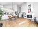 Open floor plan with hardwood floors seamlessly integrates the kitchen, dining, and living spaces at 7869 S Valentia St, Centennial, CO 80112