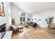 Bright living room with hardwood floors, large windows, and modern furnishings at 7869 S Valentia St, Centennial, CO 80112