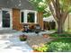 Inviting front porch with brick accents, lounge furniture, decorative planters and appealing landscaping at 7869 S Valentia St, Centennial, CO 80112