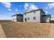 Backyard view of home shows unlandscaped lawn with an adjacent home nearby at 14378 Heritage Dr, Mead, CO 80504