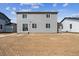 Rear view of house shows large windows and sliding glass door overlooking the unlandscaped backyard at 14378 Heritage Dr, Mead, CO 80504