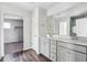 Bright bathroom features double vanity, gray cabinets, hard surface countertop, and modern fixtures at 14378 Heritage Dr, Mead, CO 80504