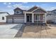 Charming two-story home with a three-car garage, neutral paint, and manicured front yard at 14378 Heritage Dr, Mead, CO 80504