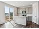 Modern kitchen featuring an island, stainless steel appliances, and sliding glass doors to the outside at 14378 Heritage Dr, Mead, CO 80504
