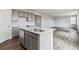 Open-concept kitchen with island, stainless steel dishwasher, and sleek gray cabinets at 14378 Heritage Dr, Mead, CO 80504