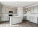 Well-lit kitchen with island, stainless steel appliances, and neutral gray cabinets at 14378 Heritage Dr, Mead, CO 80504