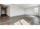 Open living room features wood-style floors, a large window, and ample natural light at 14378 Heritage Dr, Mead, CO 80504