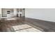 Open concept living room with wood-style flooring connecting to the kitchen at 14378 Heritage Dr, Mead, CO 80504