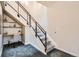 Carpeted staircase with iron railing and glass panels, along with an adjacent study nook at 4575 Tennyson St # 104, Denver, CO 80212