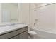 Well-lit bathroom featuring a shower-tub combo, sink, and toilet creating a clean and functional space at 13457 Valentia St, Thornton, CO 80602