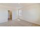 Minimalist bedroom with neutral carpet and a bright window showing plenty of natural light at 13457 Valentia St, Thornton, CO 80602