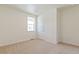 Inviting carpeted bedroom with a large window, a door, and plenty of natural light at 13457 Valentia St, Thornton, CO 80602