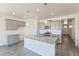 Well-lit kitchen with granite countertops, an island with sink, and stainless steel appliances create a modern space at 13457 Valentia St, Thornton, CO 80602
