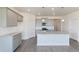 Stylish kitchen featuring gray cabinets, granite countertops, an island with seating, and stainless steel appliances at 13457 Valentia St, Thornton, CO 80602