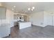 Open kitchen with a center island, gray cabinets, stainless steel appliances, and modern pendant lighting at 13457 Valentia St, Thornton, CO 80602