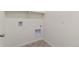 Functional laundry area with washer and dryer hookups and convenient shelving for storage at 13457 Valentia St, Thornton, CO 80602