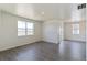 Bright living room with wood flooring, large windows, and a sliding glass door that floods the room with natural light at 13457 Valentia St, Thornton, CO 80602