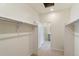 Spacious walk-in closet with carpet, access to bathroom, and ample storage space at 13457 Valentia St, Thornton, CO 80602