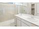 Modern bathroom with double vanity and a glass-enclosed shower at 17305 E 91St Pl, Commerce City, CO 80022