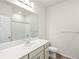 Well-lit bathroom with single sink vanity, white counter, and a shower tub at 17305 E 91St Pl, Commerce City, CO 80022