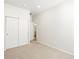 Bedroom featuring sliding closet, neutral carpet, bright white walls, leading to bathroom at 17305 E 91St Pl, Commerce City, CO 80022