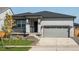 Modern ranch home with gray siding and stone accents at 17305 E 91St Pl, Commerce City, CO 80022