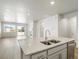 Kitchen island with double sink overlooking living room at 17305 E 91St Pl, Commerce City, CO 80022