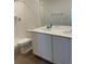 Bathroom featuring a double sink vanity, white cabinets, and a tiled shower for a clean and modern aesthetic at 21965 E 39Th Ave, Aurora, CO 80019