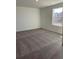 Neutral bedroom featuring a large window for plenty of natural light and soft carpeting throughout at 21965 E 39Th Ave, Aurora, CO 80019