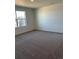 Bright bedroom featuring neutral carpet and a large window providing natural light and views at 21965 E 39Th Ave, Aurora, CO 80019