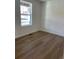 Bright bedroom with laminate flooring and a window offering natural light at 21965 E 39Th Ave, Aurora, CO 80019