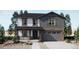 Charming two-story home featuring a welcoming front porch and a two-car garage at 21965 E 39Th Ave, Aurora, CO 80019