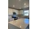 Modern kitchen featuring stainless steel appliances and an island with quartz countertops at 21965 E 39Th Ave, Aurora, CO 80019