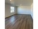 Spacious living room with laminate flooring, large window, and ample space at 21965 E 39Th Ave, Aurora, CO 80019