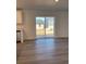 Open-concept floor plan with laminate flooring and a sliding glass door at 21965 E 39Th Ave, Aurora, CO 80019