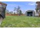 Backyard featuring large lawn and storage shed at 6893 S High St, Centennial, CO 80122