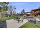 Large backyard with a firepit, deck, lawn, and shed at 6893 S High St, Centennial, CO 80122