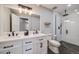Modern bathroom with double vanity, sleek fixtures, and a glass-enclosed shower with black and white tile at 6893 S High St, Centennial, CO 80122
