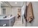 Bathroom with double vanity and modern fixtures plus view into an adjacent bedroom at 6893 S High St, Centennial, CO 80122